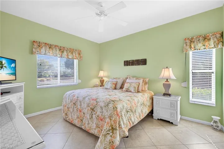 Bedroom featuring light tile patterned floors and a ceiling fan