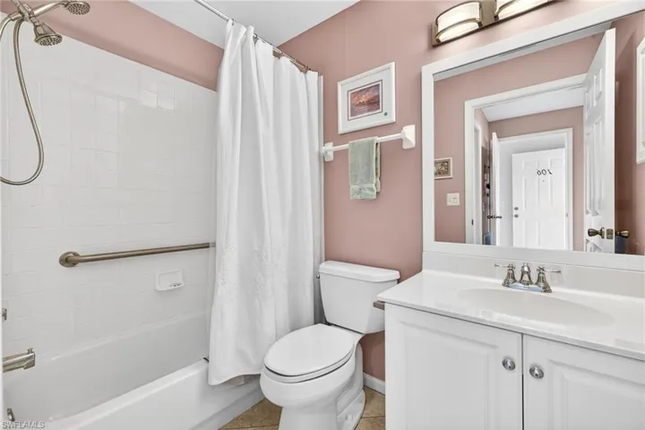 Full bathroom with shower / bath combination with curtain and vanity