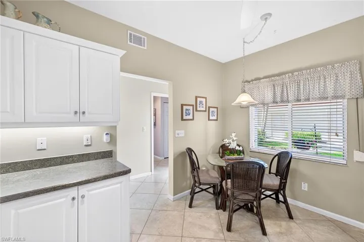 Dining space with baseboards and light tile patterned flooring