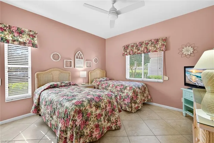 Bedroom featuring light tile patterned floors and ceiling fan