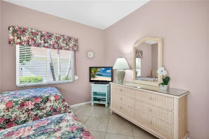 Bedroom with light tile patterned floors and baseboards