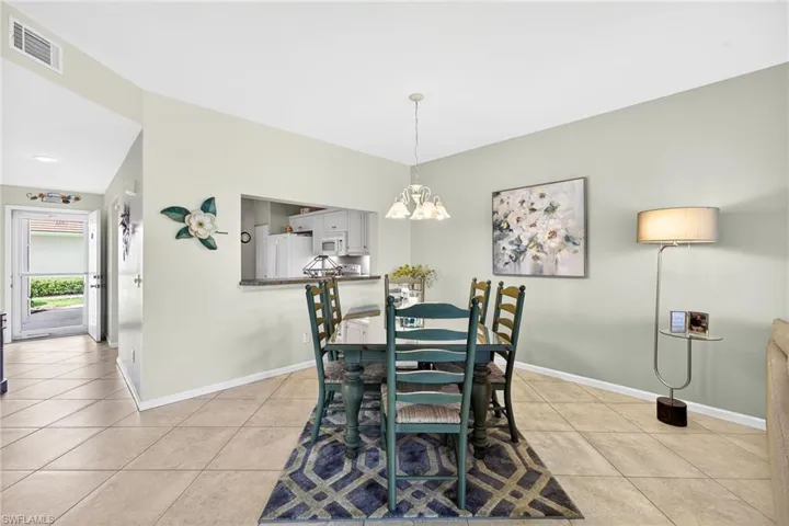 Dining area featuring a chandelier and light tile patterned floors