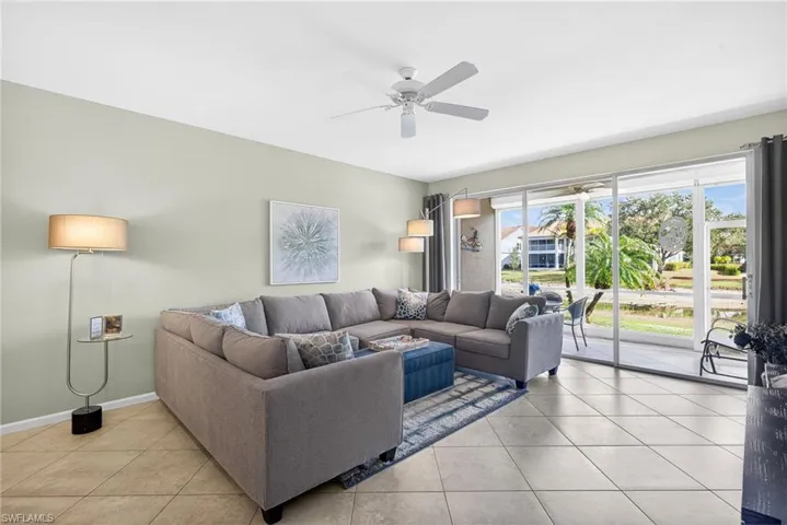 Living area featuring light tile patterned flooring and a ceiling fan