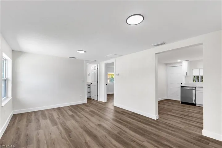 Unfurnished living room featuring a wealth of natural light and wood-type flooring