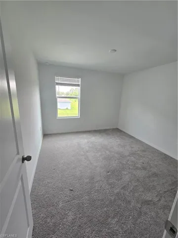 3rd bedroomCarpeted empty room featuring baseboards