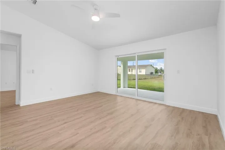 Unfurnished room with baseboards, ceiling fan, visible vents, and light wood-style floors