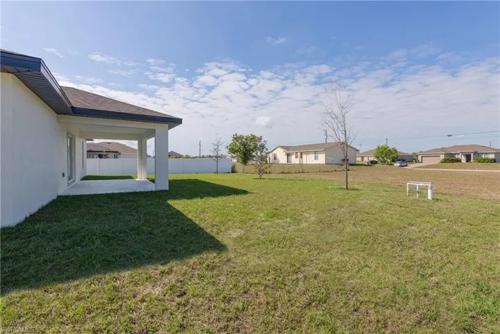 View of yard featuring a residential view, fence, and a patio