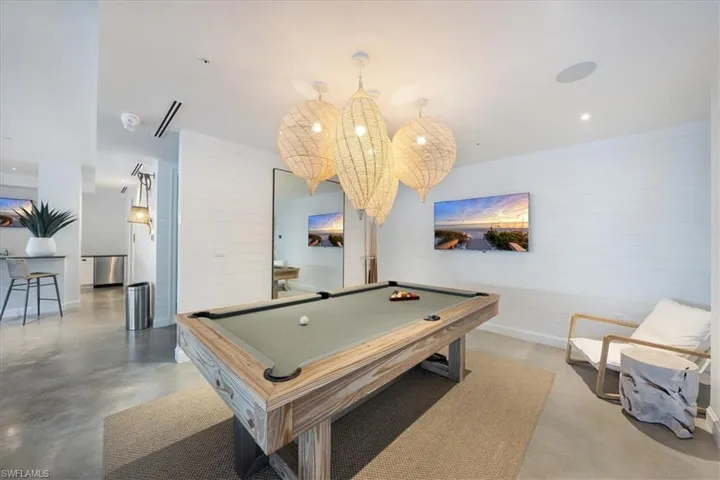 Recreation room featuring pool table, wood walls, and recessed lighting