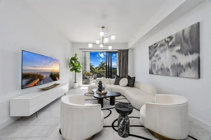 Living area featuring a chandelier and light tile patterned floors
