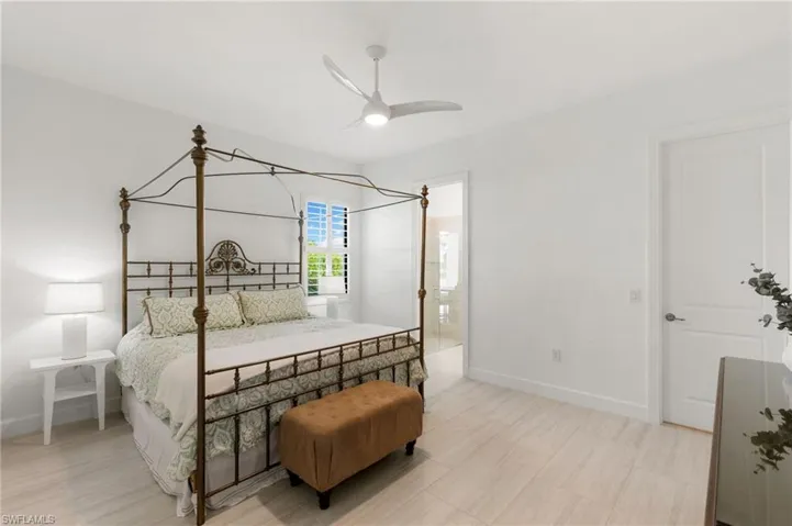 Bedroom with ceiling fan and ensuite bath