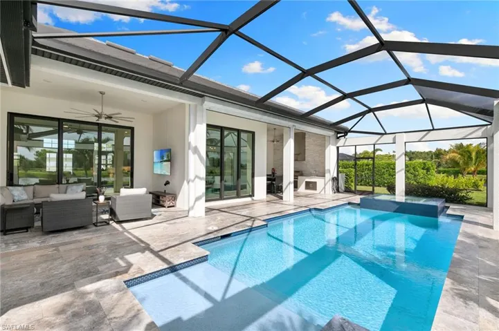 View of swimming pool with ceiling fan, a sunroom, a patio area, and an outdoor living space