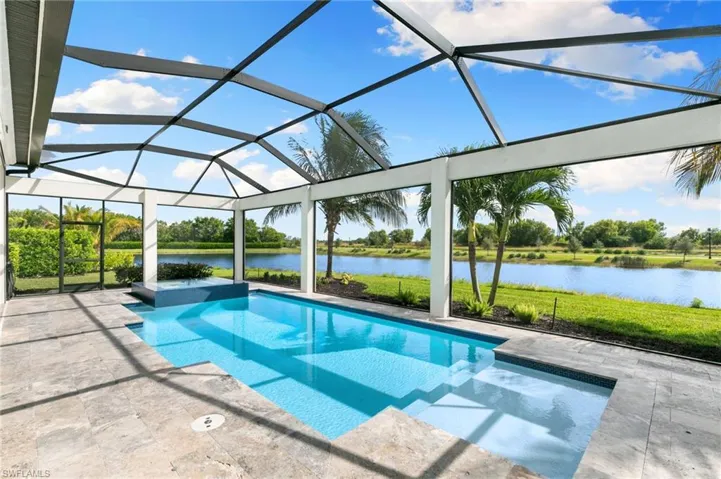 View of pool with a lanai, a sunroom, a water view, and a patio