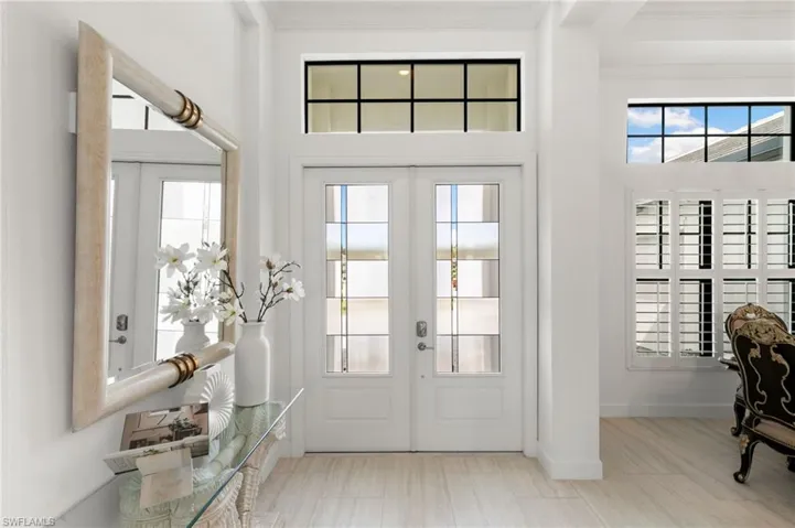 Entryway featuring ornamental molding and french doors