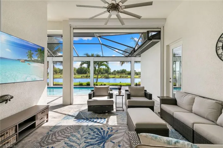 View of patio / terrace featuring a sunroom, a water view, an outdoor hangout area, a lanai, and an outdoor pool