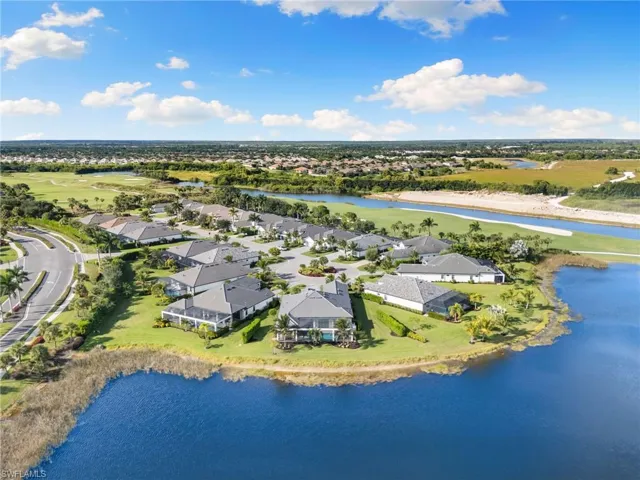 Aerial view of residential area featuring a nearby body of water