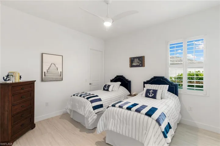 Bedroom with light wood finished floors and ceiling fan
