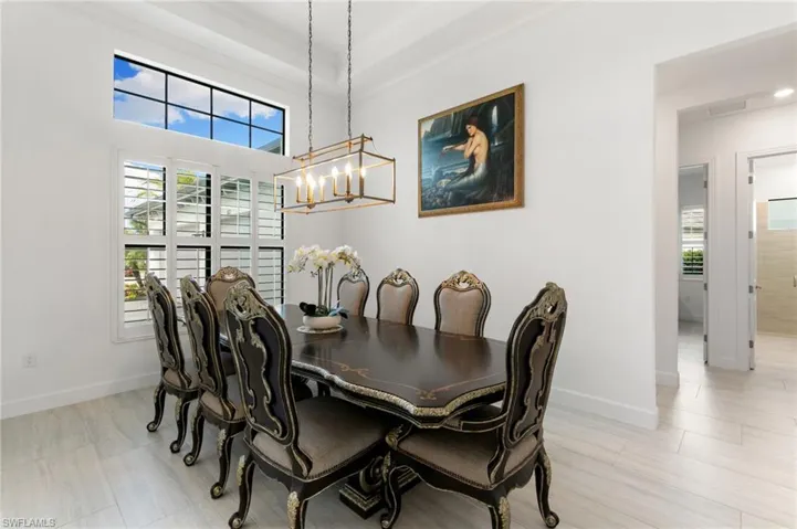 Dining space featuring ornamental molding and light wood-style floors