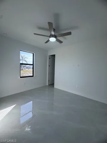Spare room featuring baseboards and a ceiling fan