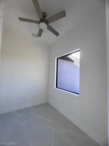 Spare room featuring a ceiling fan, baseboards, and visible vents
