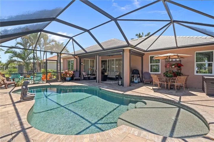 Outdoor pool featuring a patio area, ceiling fan, an outdoor living space, and a lanai