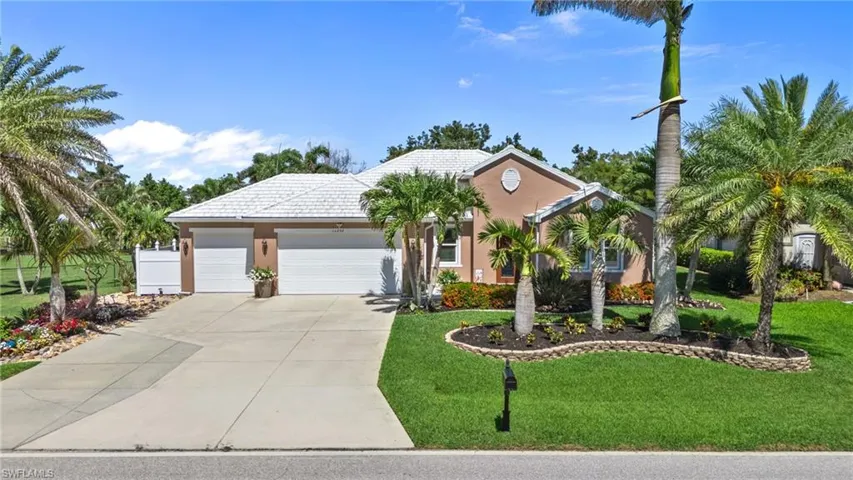 View of front of house featuring driveway, a garage, a front yard, and stucco siding