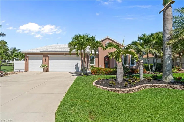View of front of home featuring driveway, a garage, a front yard, and stucco siding