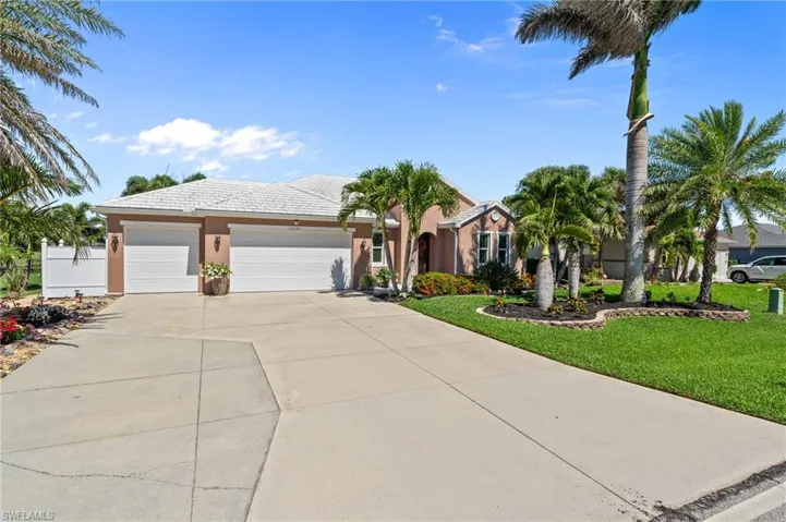 Single story home with stucco siding, concrete driveway, a garage, and a tile roof