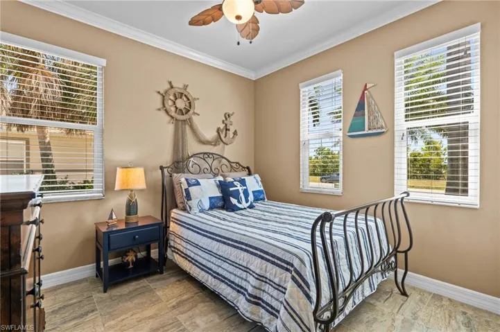 Bedroom with baseboards, crown molding, and ceiling fan