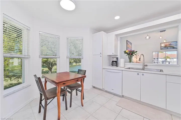 Dining area featuring light tile patterned floors and recessed lighting