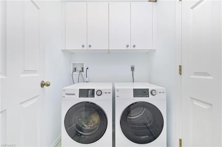 Laundry room with cabinet space and washing machine and clothes dryer