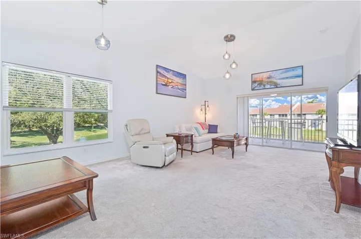 Living area featuring lofted ceiling and carpet