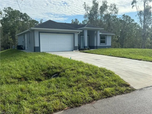 Ranch-style house with a garage and a front yard