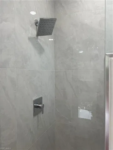 Interior details featuring a tile shower