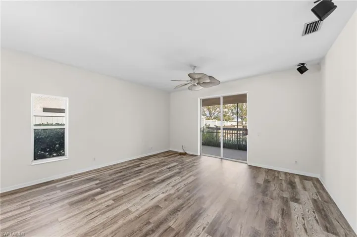 Spare room with a ceiling fan and dark wood finished floors