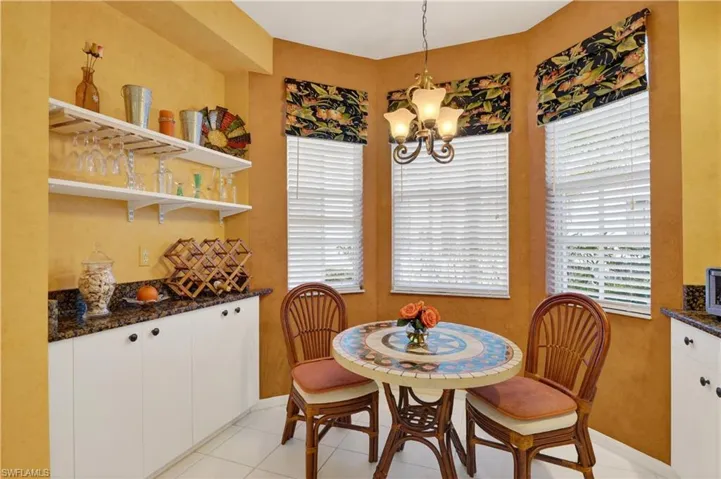 Dining room featuring light tile patterned floors, a chandelier, and plenty of natural light