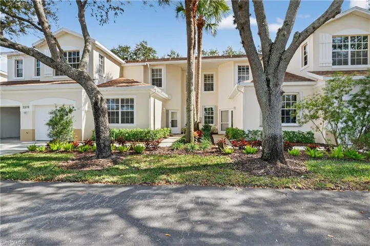 View of front of home with stucco siding and a garage