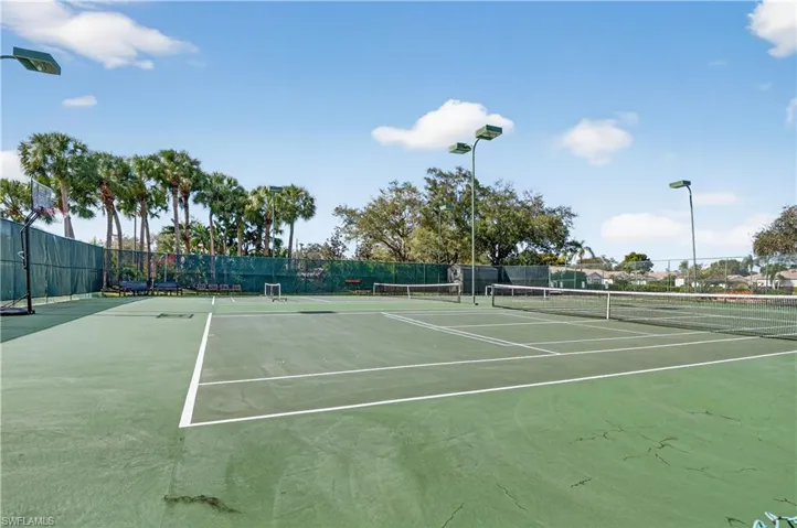 View of tennis court featuring community basketball court