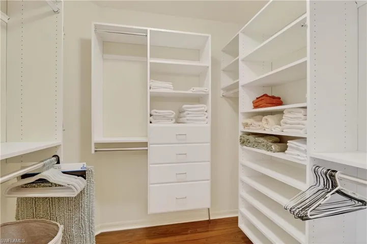 Spacious closet featuring dark wood-style floors
