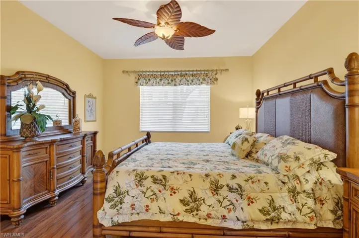 Bedroom with a ceiling fan and dark wood finished floors