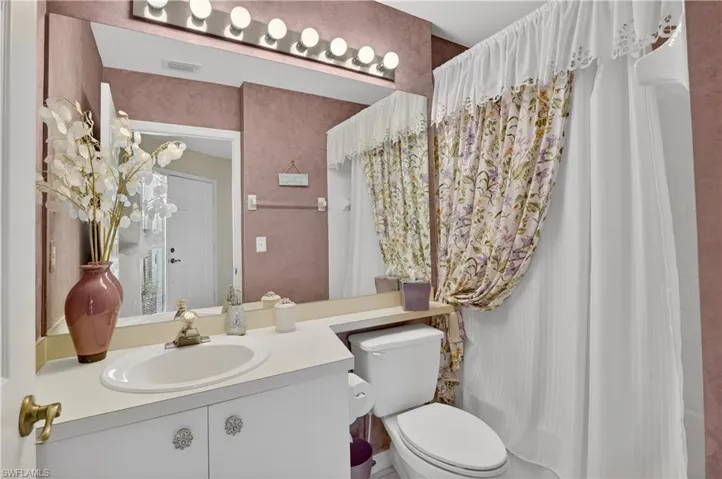 Bathroom with vanity and shower / tub combo
