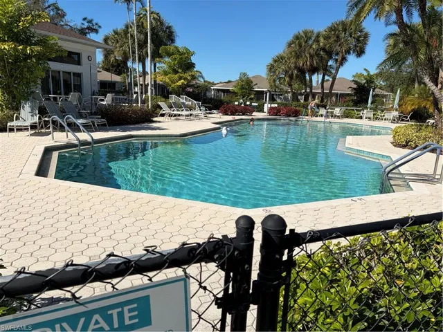 Community pool with a patio