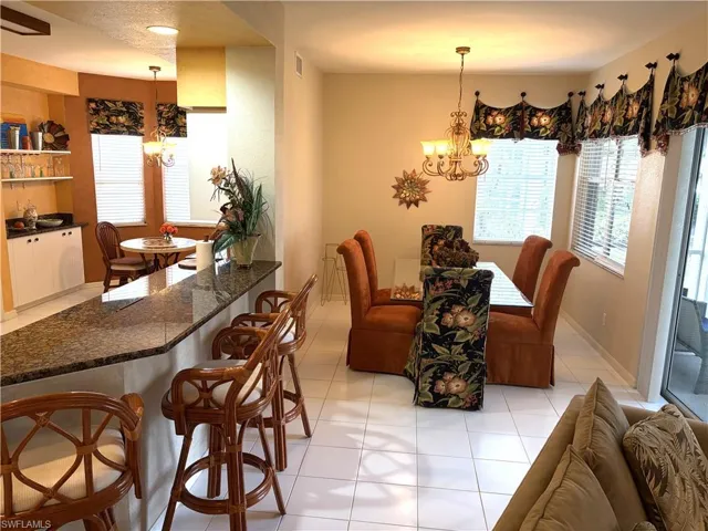 Dining area featuring a chandelier and light tile patterned floors