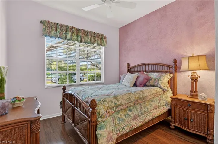 Bedroom with dark wood-type flooring and ceiling fan