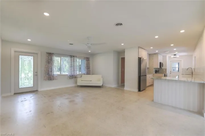 Unfurnished living room with ceiling fan
