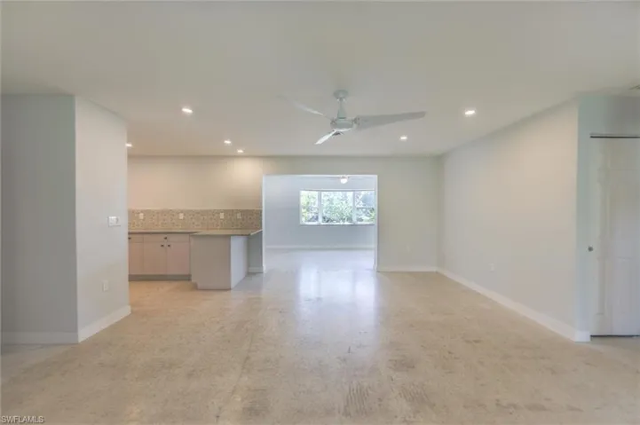 Unfurnished living room with ceiling fan