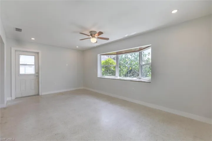 Spare room with a healthy amount of sunlight and ceiling fan