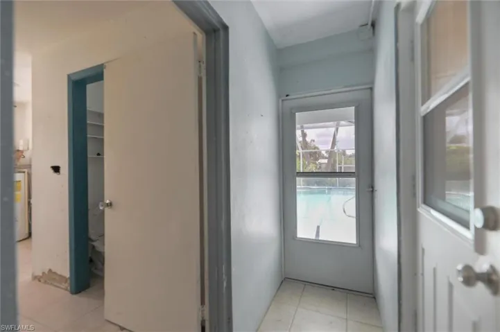 Bathroom 3 - pool bath and laundry room with light tile patterned flooring