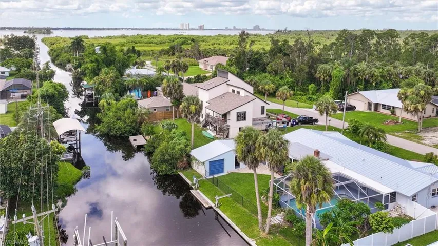 Birds eye view of property with a water view