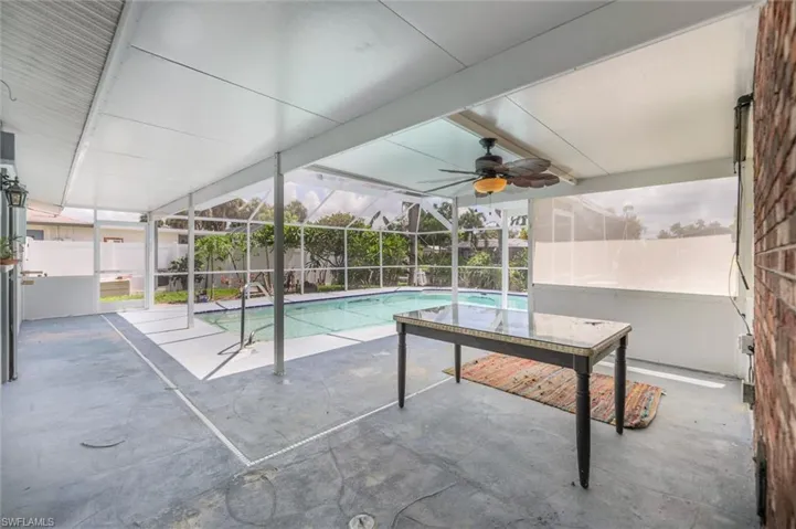 View of pool with ceiling fan