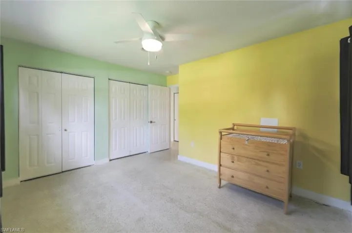 Bedroom featuring two closets and ceiling fan